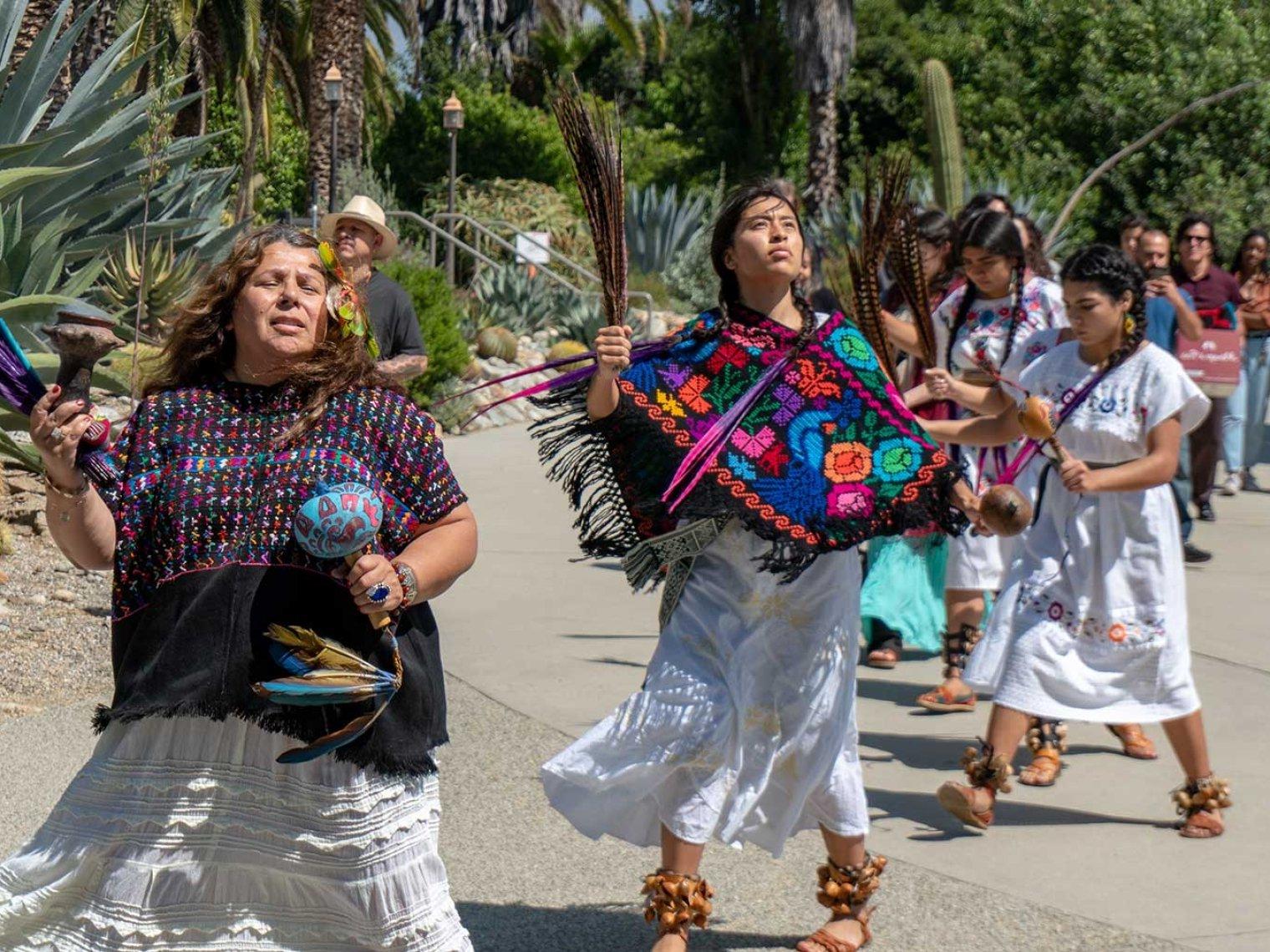 indigenous californianian dance in front of the grove house